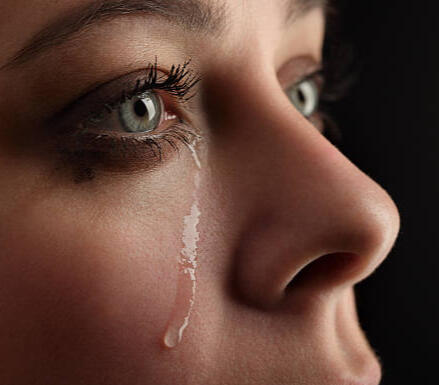 Tears of Stress or Tears of Gratitude? Georgia Whole Life Final Expense – Legacy of Love | Crook & Covenant Close-up side profile of a young woman with a tear rolling down her face, illustrating the financial and emotional impact of lacking final expense coverage in Georgia.